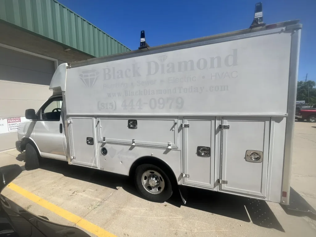 The used service van as it arrived, with the previous owner's branding removed but still ghosted across the panel.