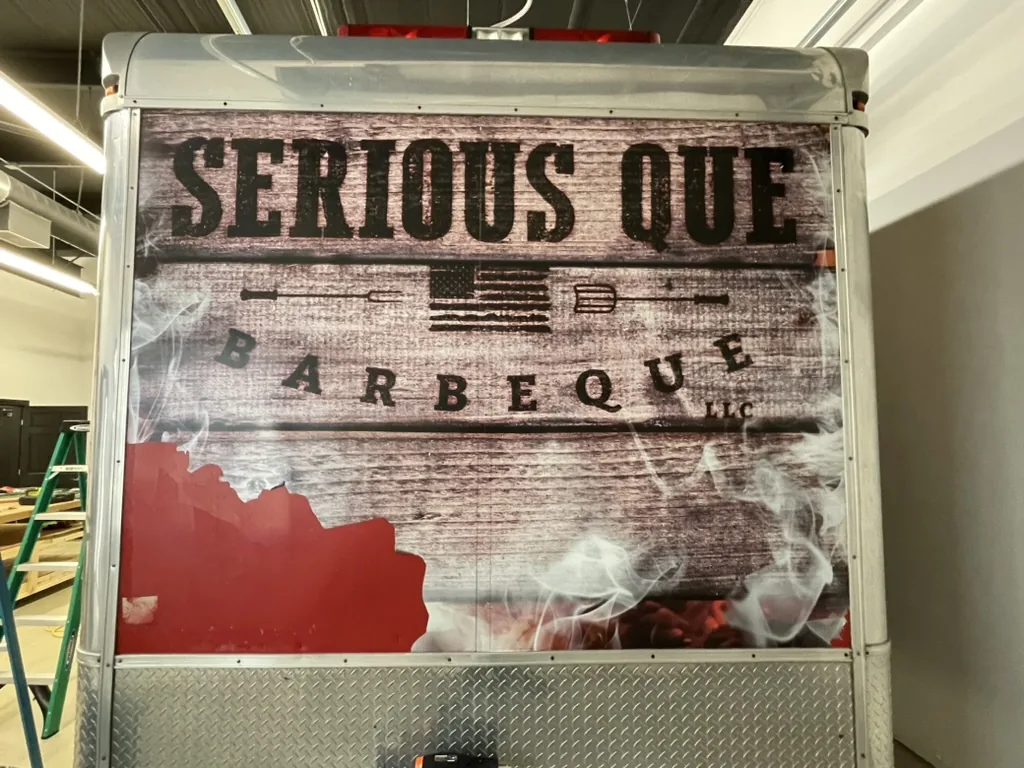 Rear of the trailer showing the previous business branding before removal.