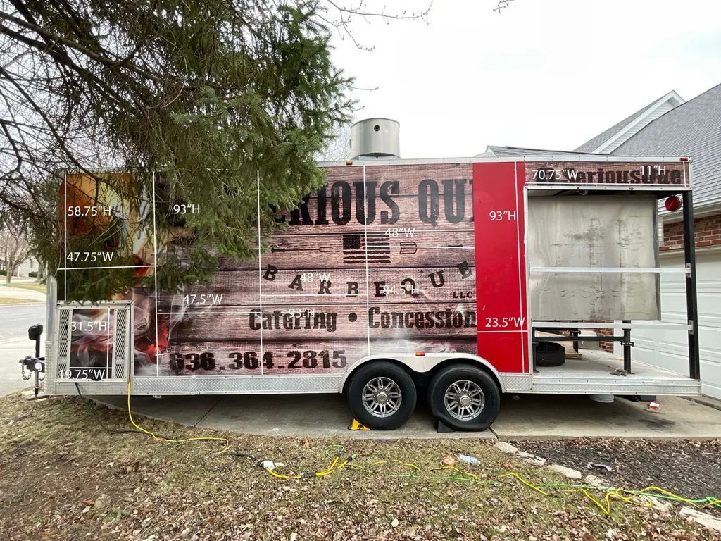 Panel measurements marked across the Hink's Smokehouse trailer during the on-site survey before design.