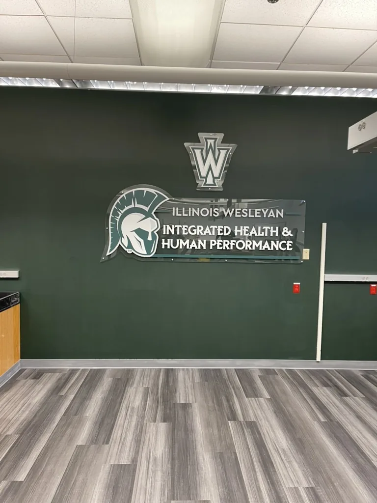 Acrylic standoff-mounted lobby sign for Illinois Wesleyan Integrated Health and Human Performance, Bloomington, IL.