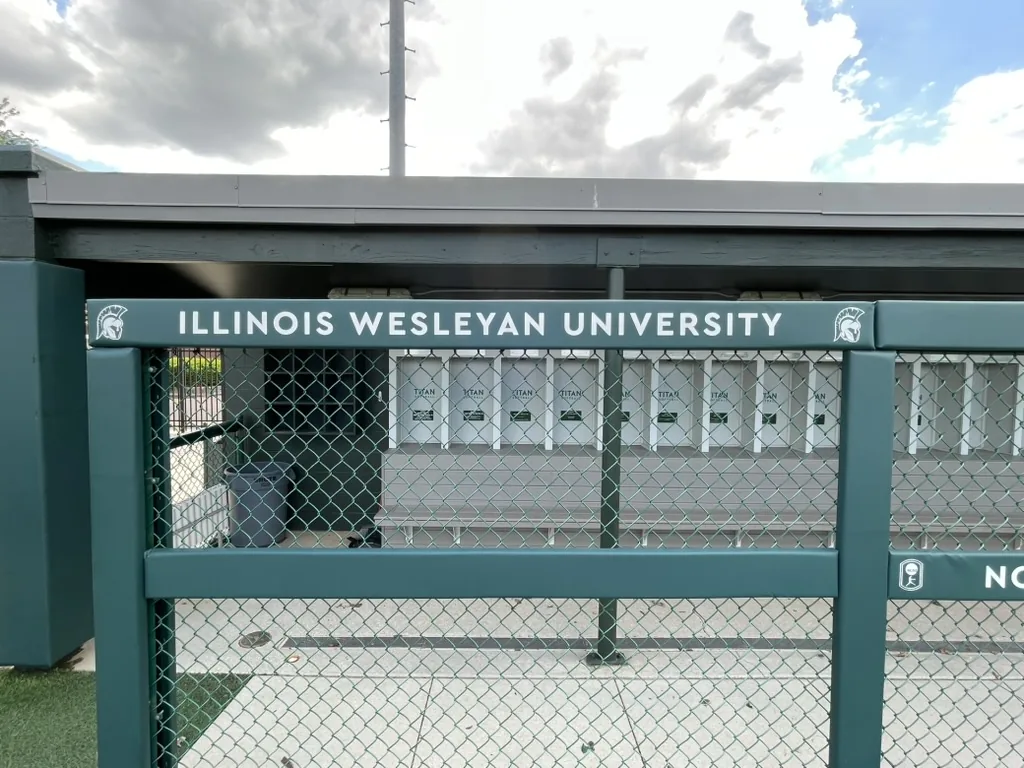 Illinois Wesleyan University lettering on the softball dugout at the Bloomington, IL campus.