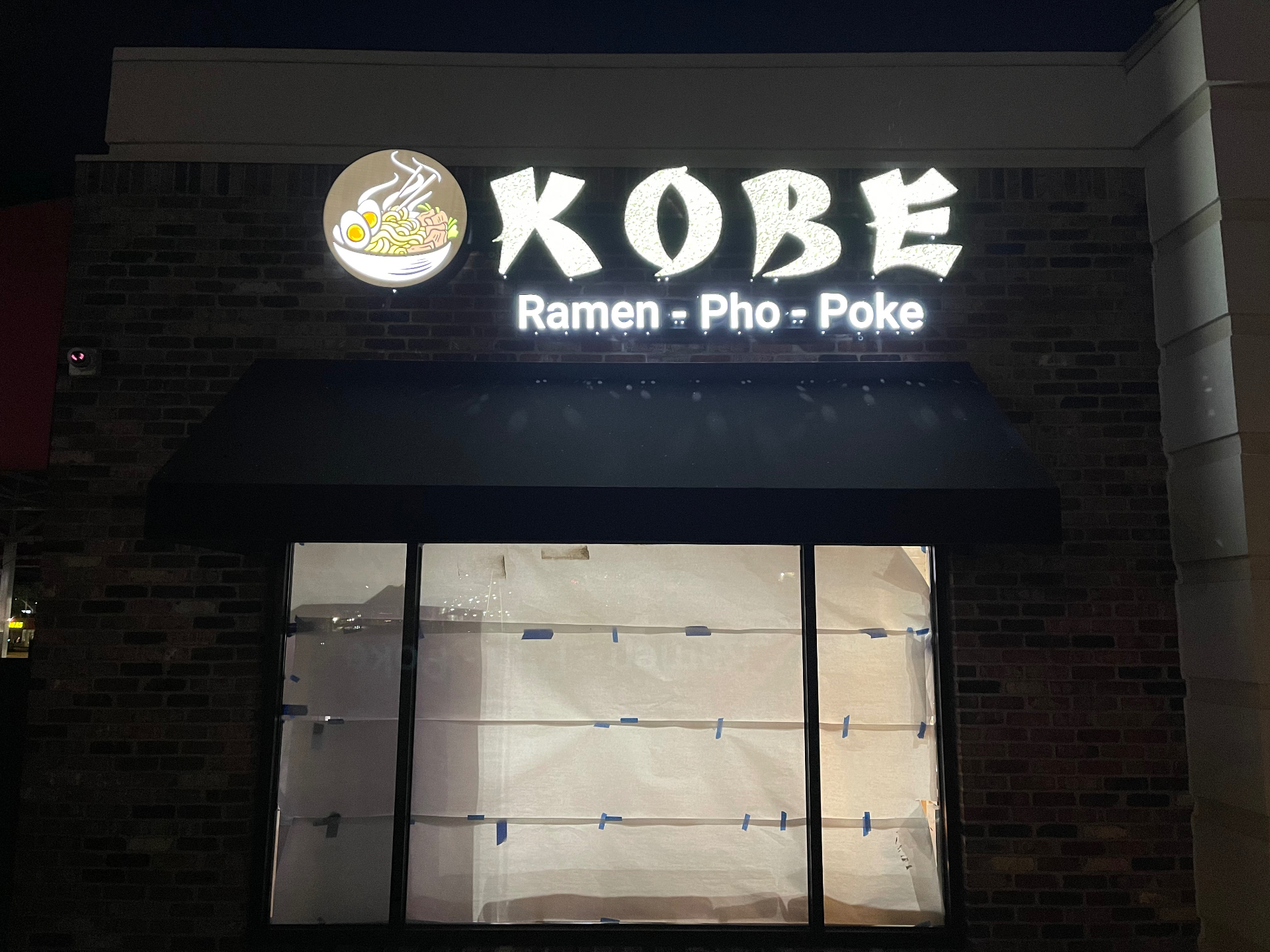 Kobe Ramen storefront facade with illuminated channel letters at night by Simply Divine Signs & Wraps.
