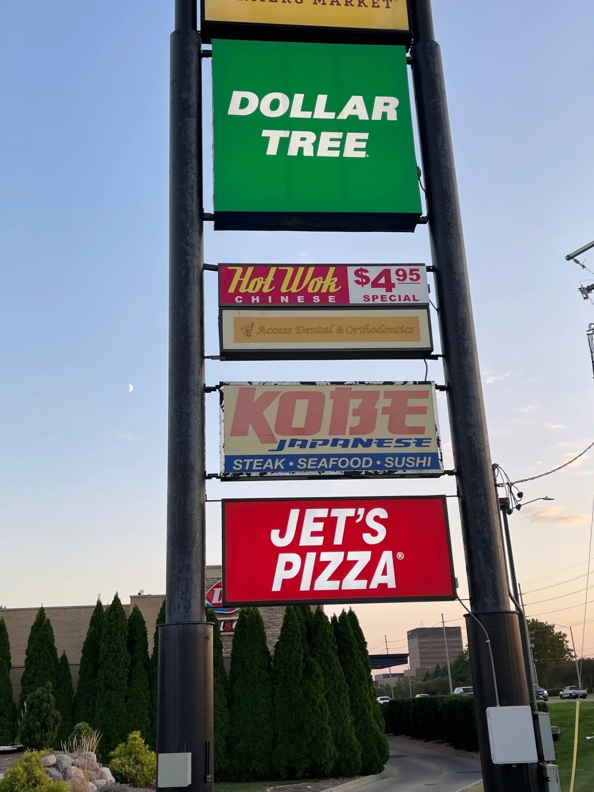 Faded and peeling original Kobe Japanese Steak House pylon sign face before replacement in Bloomington, IL.