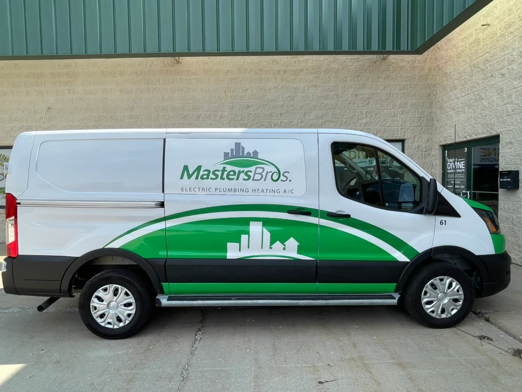 Passenger side of the finished Ford Transit, with the Masters Bros. logo and service lines on the upper panel and a green swoosh and skyline across the lower half.
