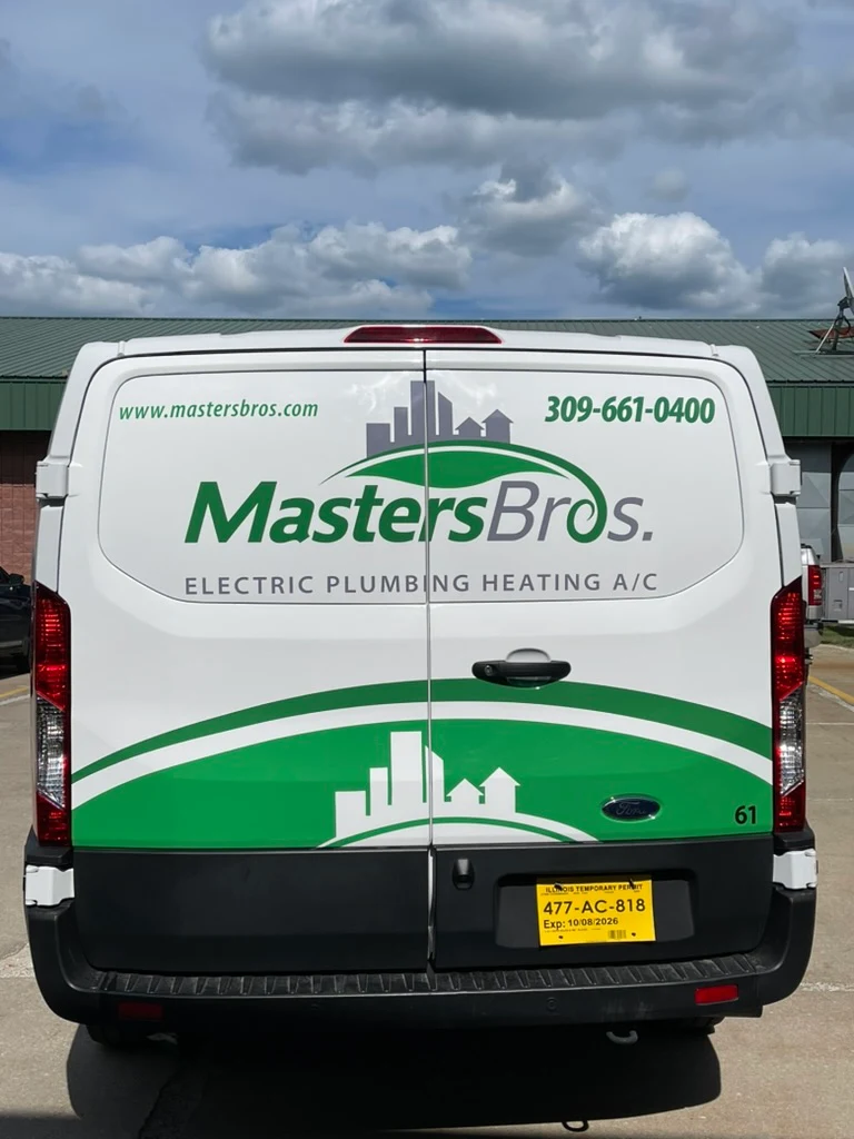Rear doors of the Ford Transit, with the web address, phone number, logo, and service lines above a green swoosh and skyline.