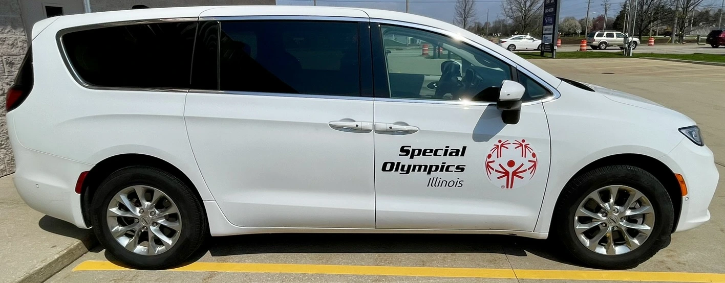 Special Olympics Illinois Chrysler Pacifica minivan with cut vinyl decals and lettering along the side, completed in Normal, IL.