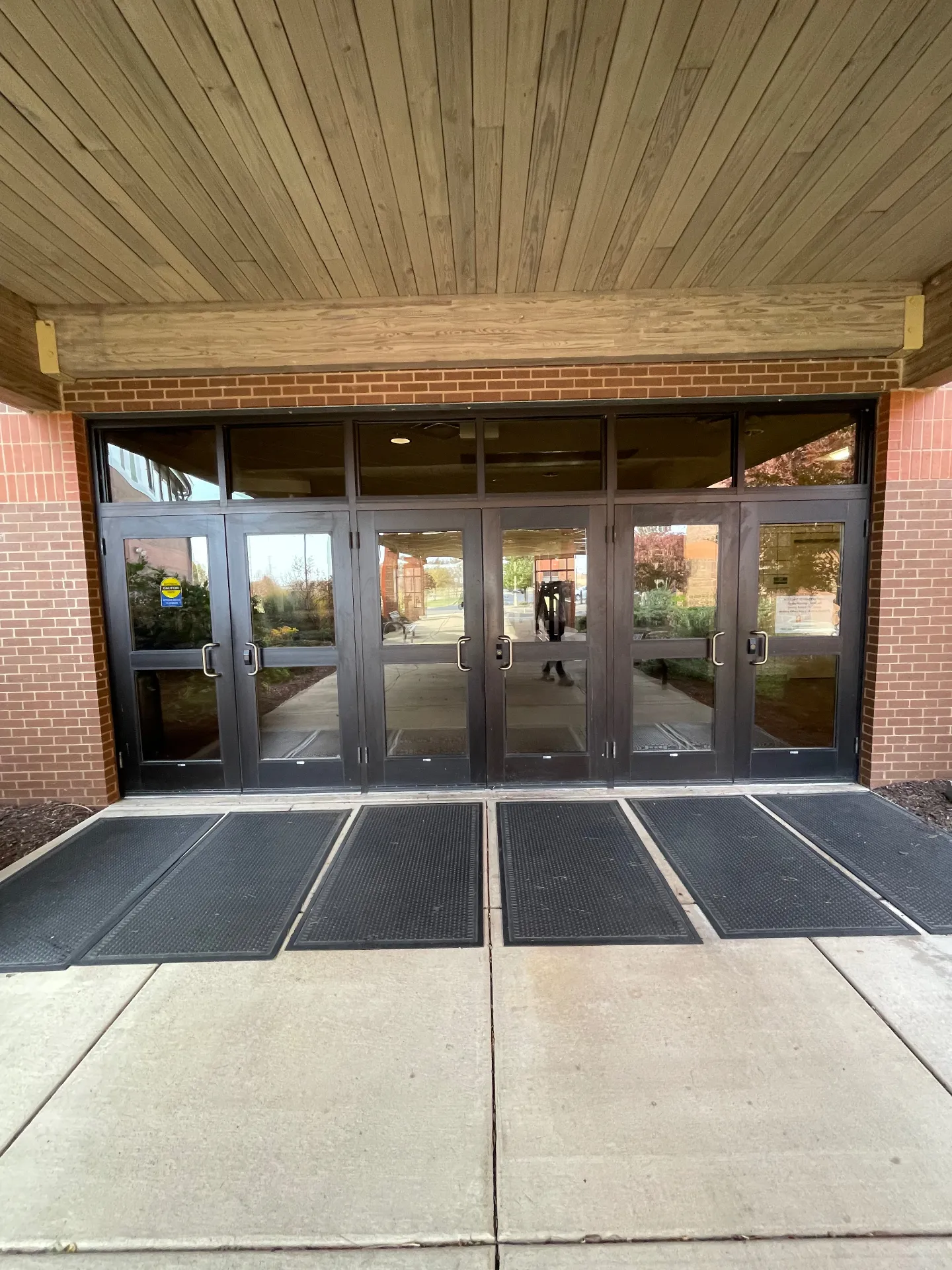 Grace Church main entrance bank of glass doors in Morton, IL before Simply Divine Signs & Wraps installed Welcome window graphics.