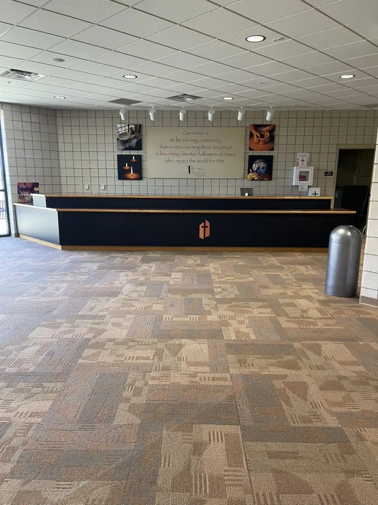 The vision desk after its wrap, with a matte black front and the Grace Church shield in orange.