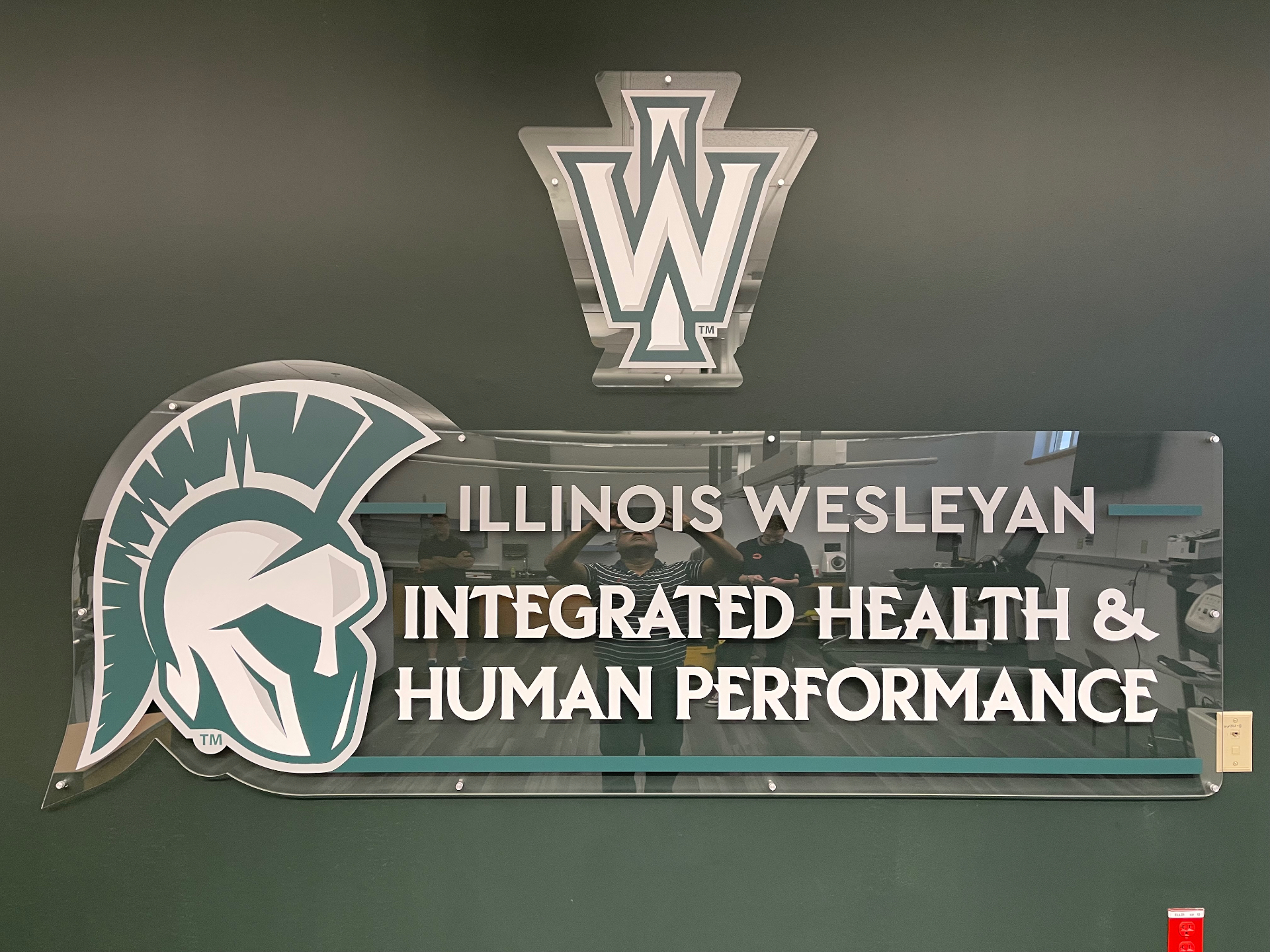 Illinois Wesleyan University dimensional lobby sign with brushed-metal letters