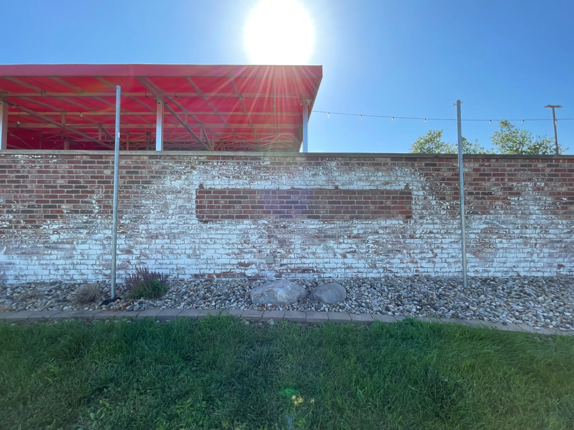 Kobe Ramen exterior brick wall before — weathered painted brick where new signage and branding would be installed.