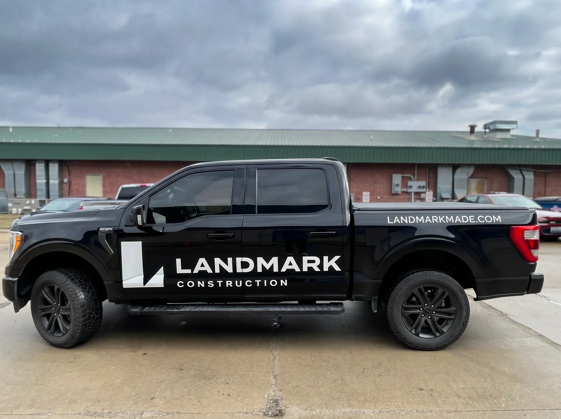 Landmark Construction — Minimalist yet bold contractor pickup branding